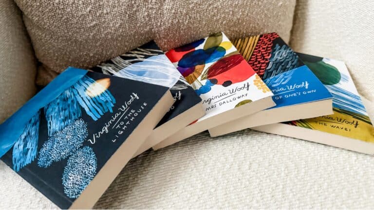A flatlay of classic literature books with my Virginia Woolf collection on my reading chair