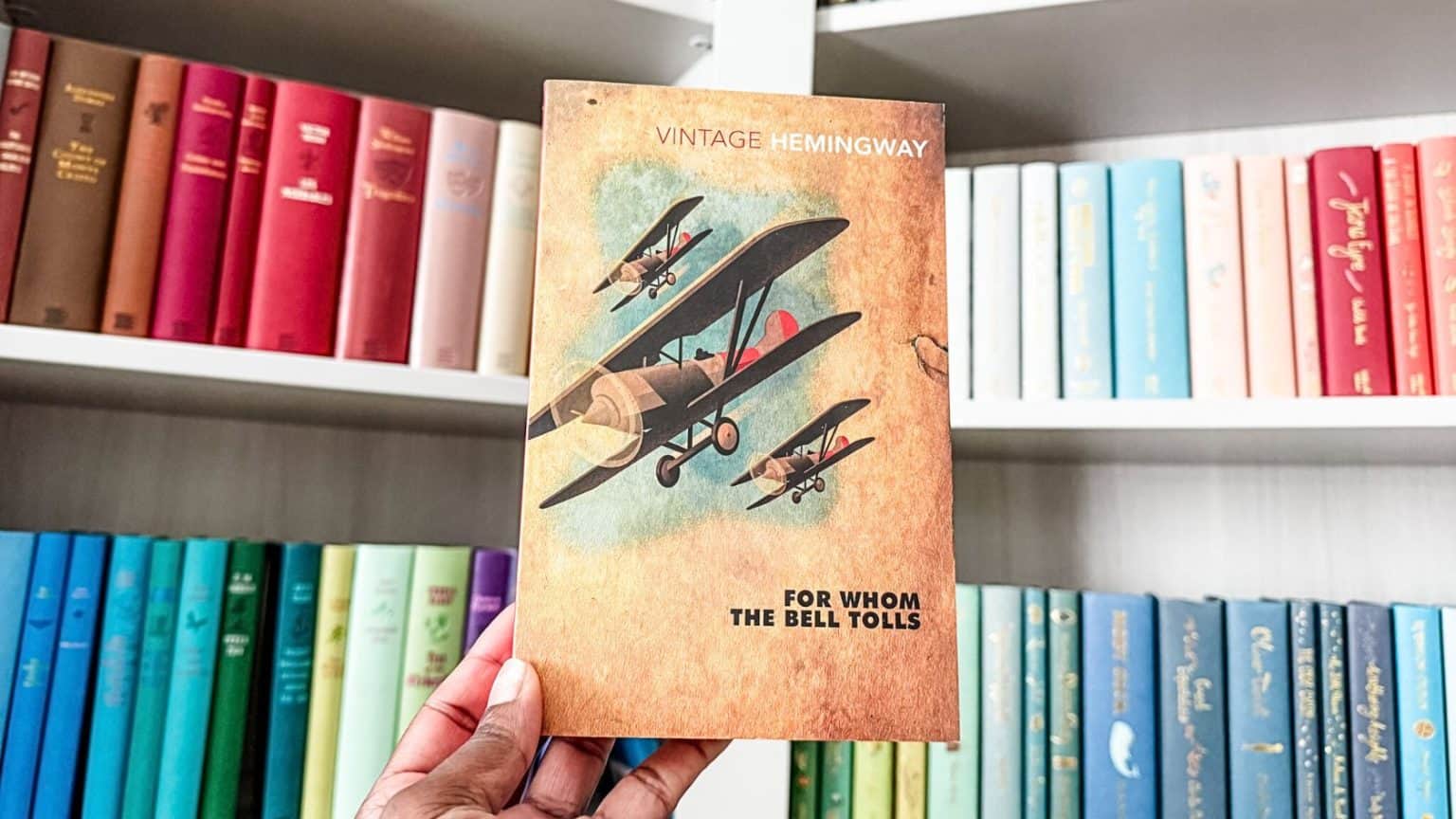 Book cover of For Whom The Bell Tolls set against bookshelves