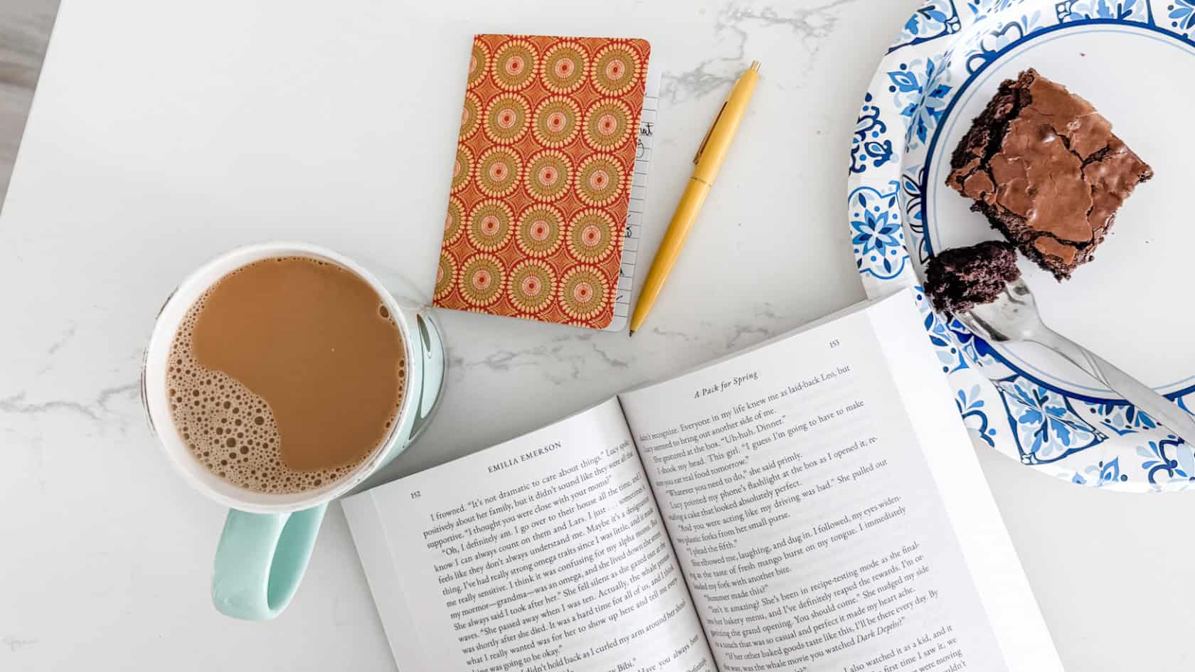 cozy lifestyle planning menu for homebodies with coffee, book, journal, brownie