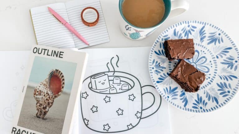 my soft week menu cozy setup with Cozy Reading coloring book, coffee, brownie, outline trilogy and journal with pen