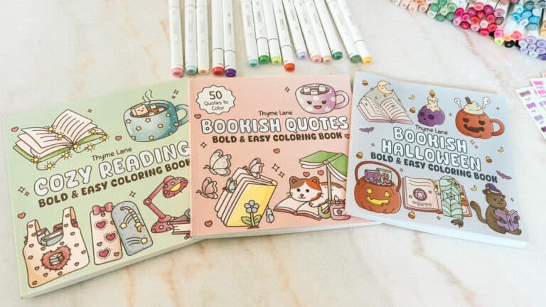 Flatlay of Cozy Reading, Bookish Quotes, and Bookish Halloween coloring books by Thyme Lane with Ohuhu markers
