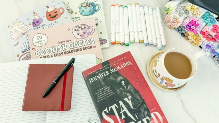 my soft week menu flatlay featuring coloring books, my journal, coffee and my book stay buried by Jennifer McMahon