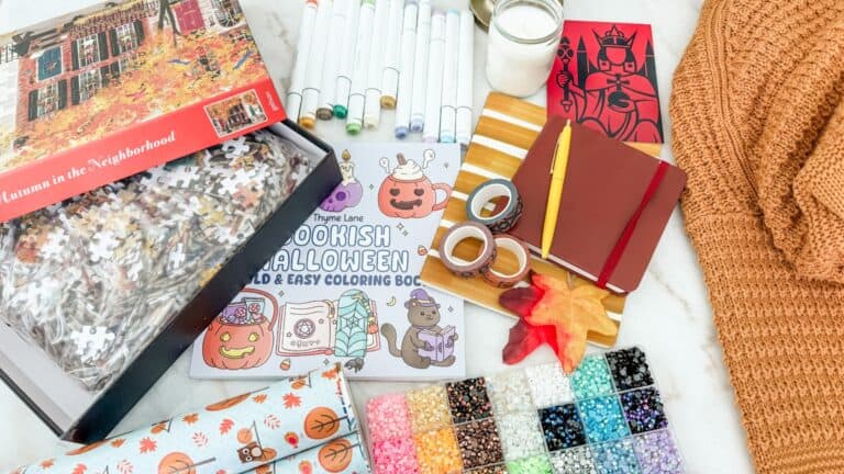 Frugal fall activities with adult coloring books, markers, puzzles, books, blanket, journal, and autumn leaves